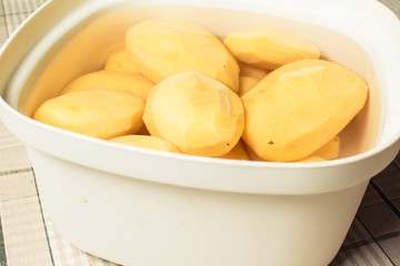 Cleaned potatoes lie in water from blackening of nitrates.