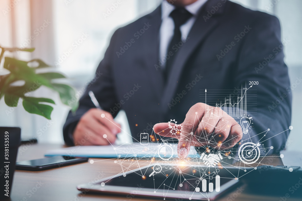 Poster businessman using tablet analyzing sales data and economic growth graph chart .e-commerce and network, business strategy. digital marketing.planning business and financial concept