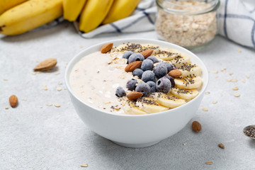 Smoothie bowl with blueberry, chia, banana, almond and yogurt. Delicious and healthy Breakfast. The concept of healthy eating.