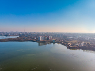 Fototapeta na wymiar Aerial landscape photo of Morii Lake , Bucharest, Romania with many buildings in the distance.