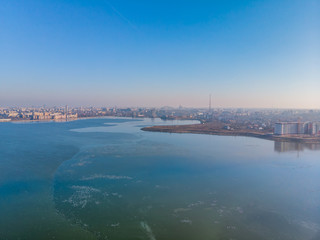Fototapeta na wymiar Aerial landscape photo of Morii Lake , Bucharest, Romania with many buildings in the distance.