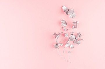 Cute girlish new year background - elegant silver bouquet on pastel pink paper, top view, copy space.