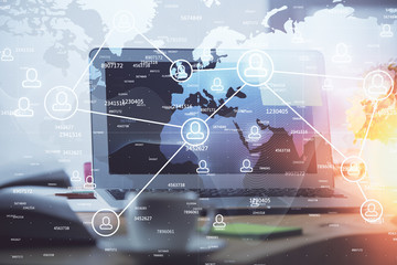 Computer on desktop with social network theme icon. Multi exposure. Concept of international connections.