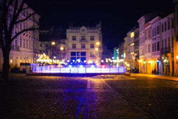 Out of focus image of old european city night street. Night street neon lights