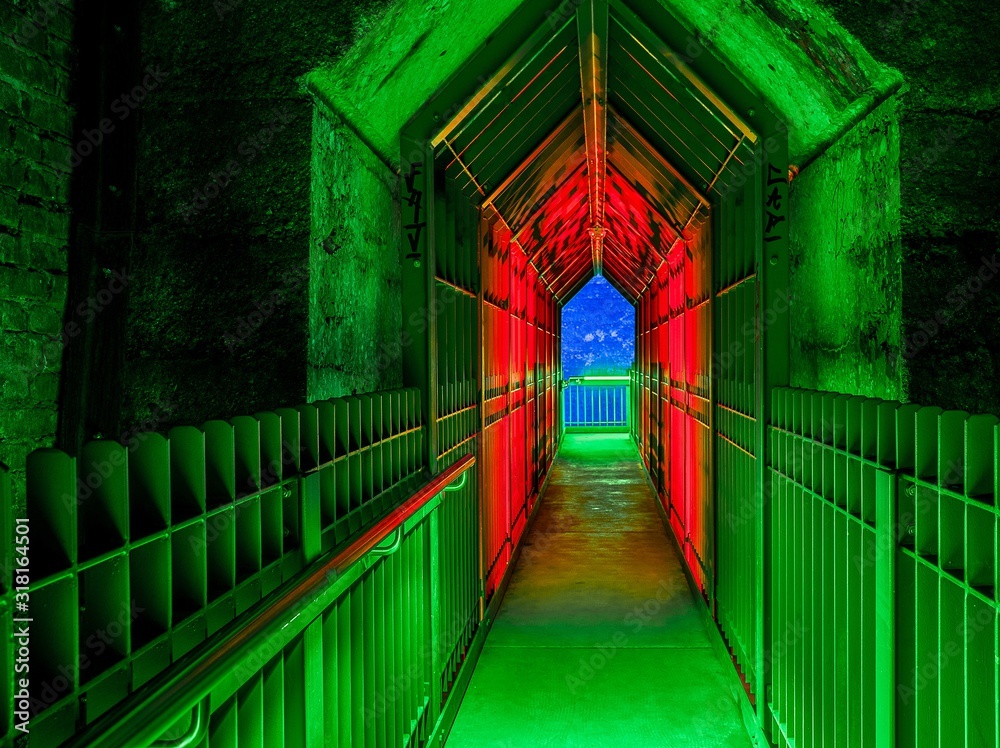 Canvas Prints beautiful shot of a narrow hallway with colorful lights headed to the view of a blue sky