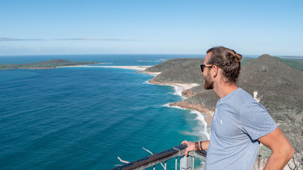 Man standing on the edge of a cliff viewpoint