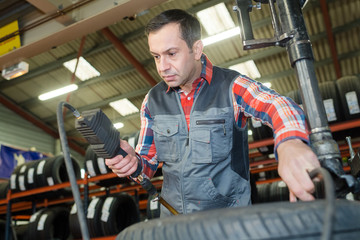 mechanic measuring car tyre pressure © auremar