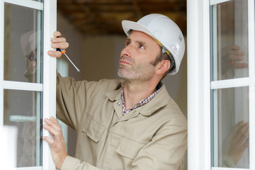 construction worker installing new windows