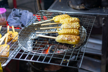 Sticky rice toasted on a charcoal grill