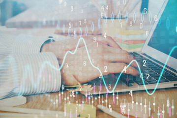 Multi exposure of stock market graph with man working on laptop on background. Concept of financial analysis.