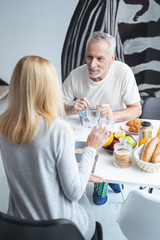 Man having breakfast with woman at home stock photo