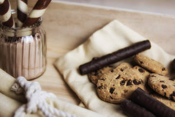 Chocolate waffles in a basket with cookies with and chocolate sprinkles. Close up and depth of field