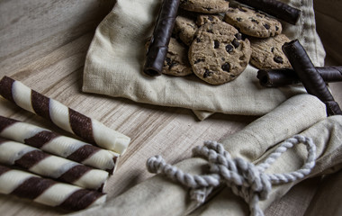 Chocolate waffles in a basket with cookies with and chocolate sprinkles. Close up and depth of field