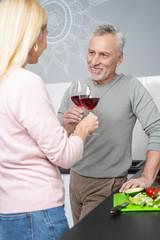 Drinking wine in the kitchen before eating supper stock photo