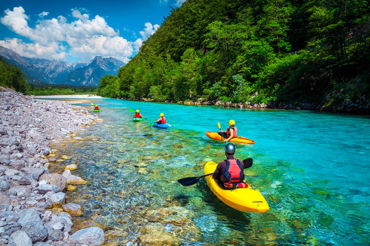 Sporty kayakers on the beautiful turquoise Soca river, Bovec, Slovenia
