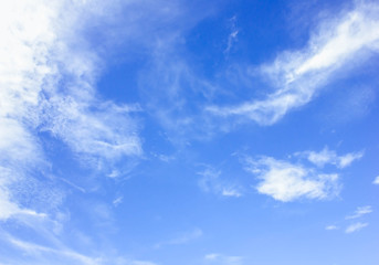 Sky background is vast with white clouds.