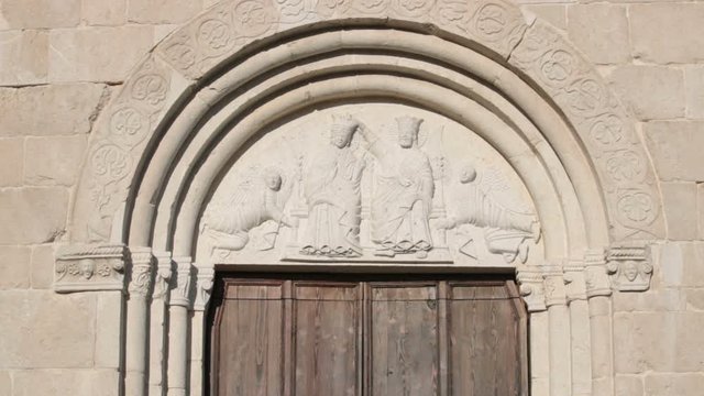 coronation of the virgin, tilt shot of one of entrance of saint Andrea churc in Venzone