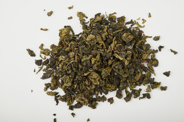 Dry and fresh tea leaves isolated on white