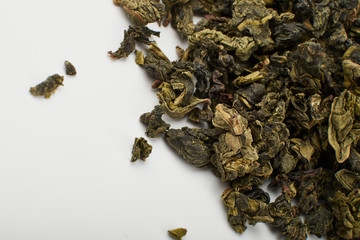 Dry and fresh tea leaves isolated on white