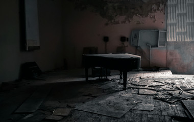 old black piano in the room of an abandoned house in Chernobyl Ukraine