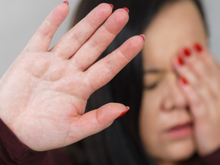 Scared woman with stop hand gesture