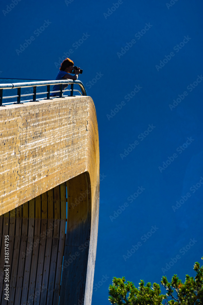 Poster tourist take photo on stegastein viewpoint norway