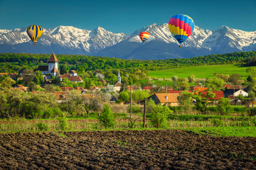 Rural landscape with Hosman village and hot air balloons, Romania