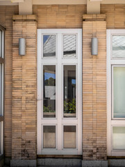 Glass  doors with turquoise frames at red bricked