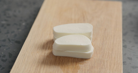 Closeup sliced fresh mozzarella on oak board