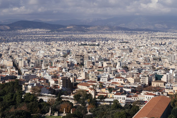 Fototapeta na wymiar Athens, Greece - Dec 20, 2019: View from the entrance of the Acropolis of Athens towards the Ancient Agora and across the city of Athens, Greece