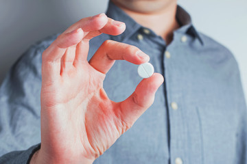 Close-up shot of male hand holding tablet