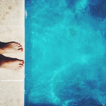 Low Section Of Woman Standing Poolside