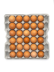 Eggs in the cardboard egg tray on white.