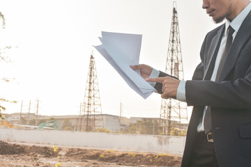 Project manager holding paper blueprint inspection estate construction building project