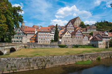 Fototapeta na wymiar Schwäbisch Hall, Germany - July 25, 2019; City view with half timbered houses on the waterfront of a touristic town on the romantic road in Bavaria