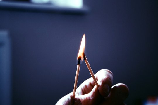CLOSE-UP OF CROPPED HAND holding matches