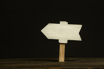 Wooden signboard on black background. Front view, closeup