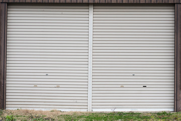 An old metal roller shutter at a closed store front. 