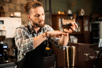 Barman working at bar and wearing uniform