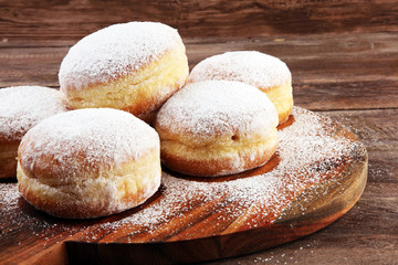 German donuts with jam and icing sugar. Carnival powdered sugar raised donuts for party