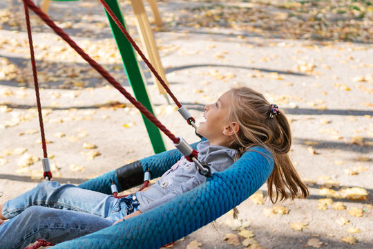 child swinging on a swing