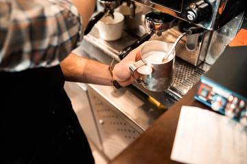 Close up of skillful bartender working in coffee house