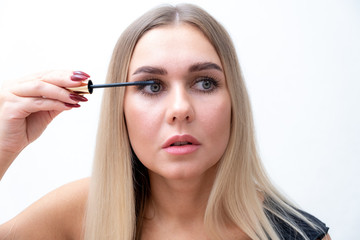 Woman mascara applying brush, female portrait makeup eyelashes
