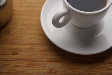 Obraz na płótnie Canvas Coffee in a café with white cup