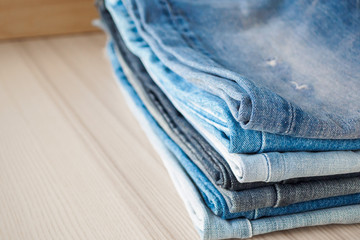 denim blue jeans stack on wood table background