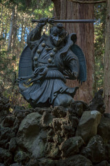 japanese mythology statue on rocks