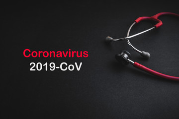 Stethoscope with words CORONA VIRUS 2019 COV on black background. Selective focus and crop fragment