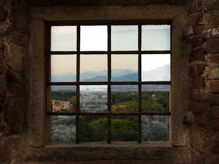 A view through barred window to the beautiful panorama of a mountain city