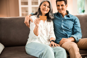Happy adult man hugging her wife at home
