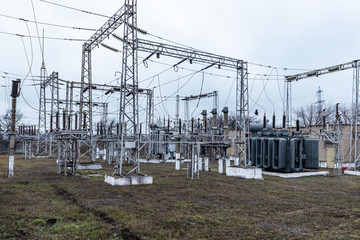 High voltage urban electrical substation with high voltage wires and transformers.